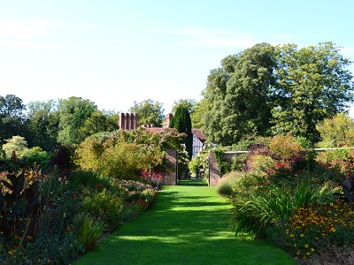 Pathway through herbaceous borders. at Pashley Manor Gardens