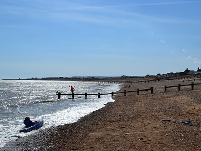 View west along the shoreline to Sovereign Harbour Eastbourne. at Pevensey Bay Beach